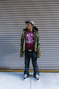 Model in burgundy washed Saint Vanity university crewneck, full-length streetwear styling