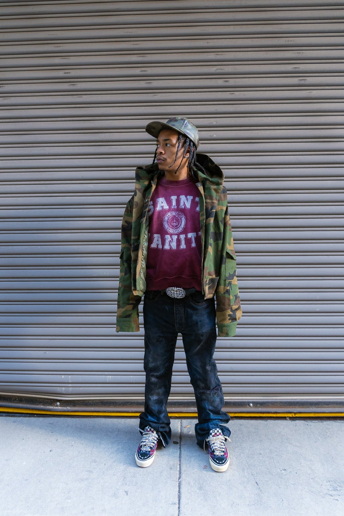 Model in burgundy washed Saint Vanity university crewneck, full-length streetwear styling